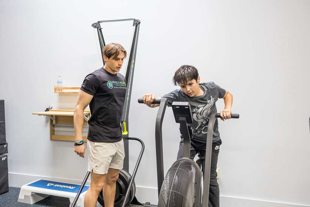 Patient working with a provider at a performance physical therapy clinic in Shirley